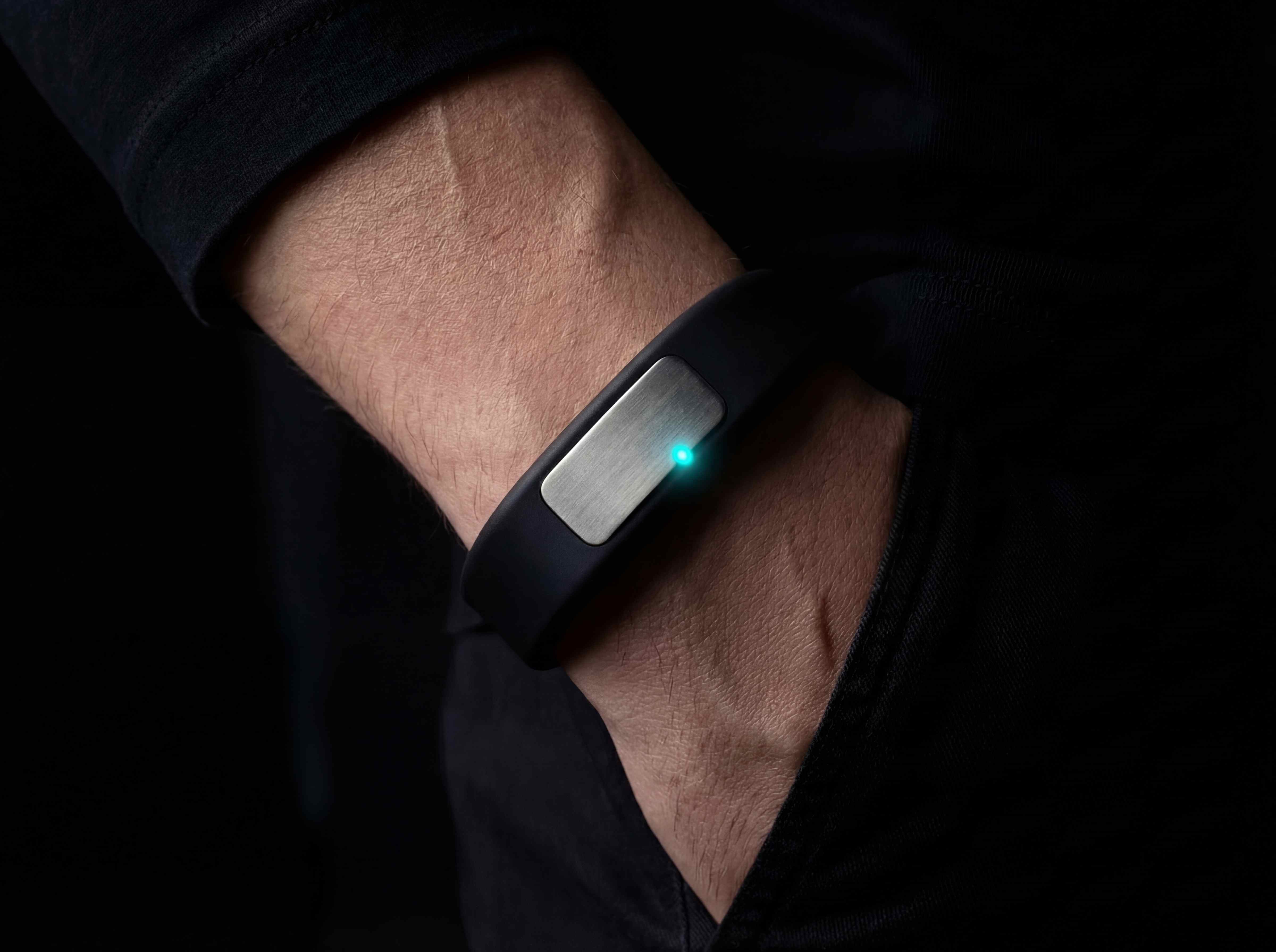 Nudge band worn on wrist with cyan LED glowing